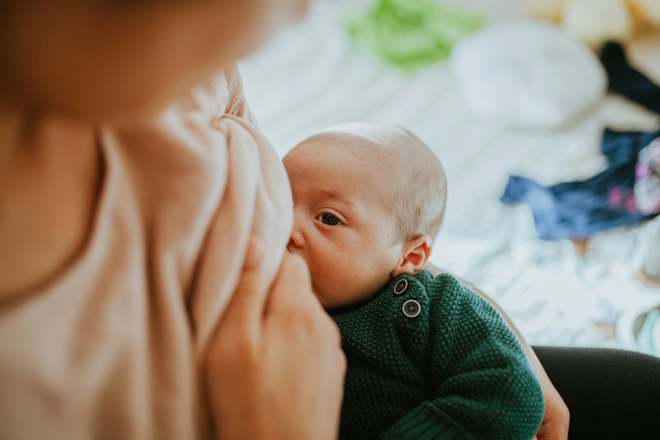 Infant looking up at mother while nursing