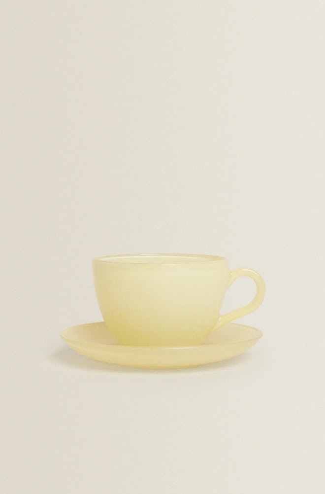 Pastel-coloured glass coffee cup and saucer
