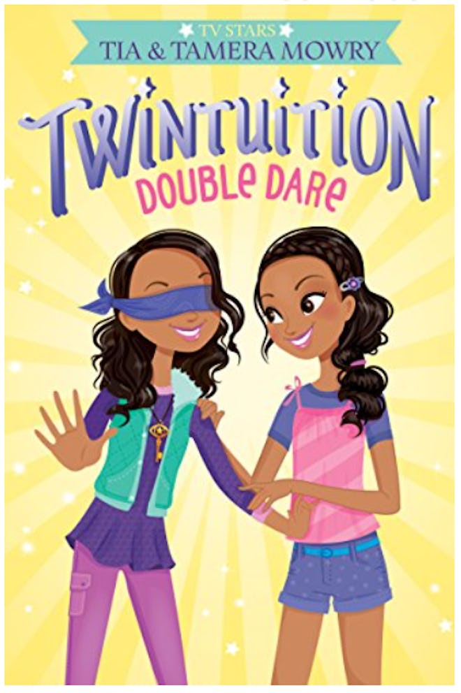 Book cover; twin girls smiling, one with blindfold over her eyes