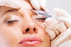 Woman getting a Botox injection in forehead