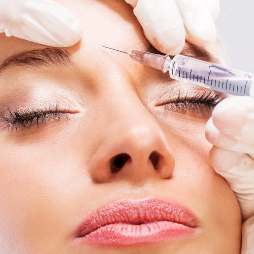 Woman getting a Botox injection in forehead