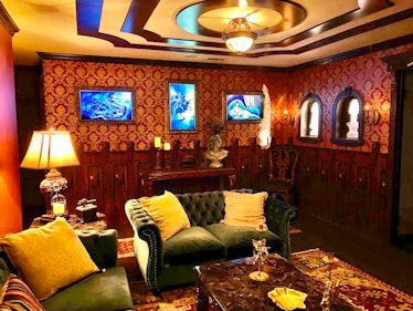 The main lounge in the Airbnb inspired by Disney's Haunted Mansion are ghostly illusions like changi...