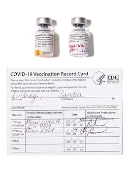 vials of vaccine and a covid-19 vaccination record card