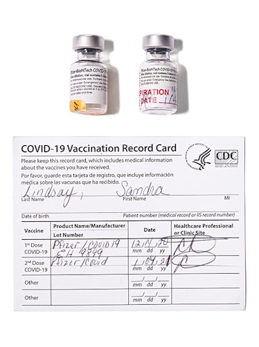 vials of vaccine and a covid-19 vaccination record card