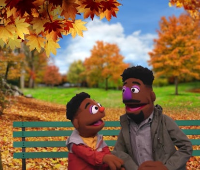 A still from "Explaining Race," showing two new Black muppet characters, Wes and his father, sitting...