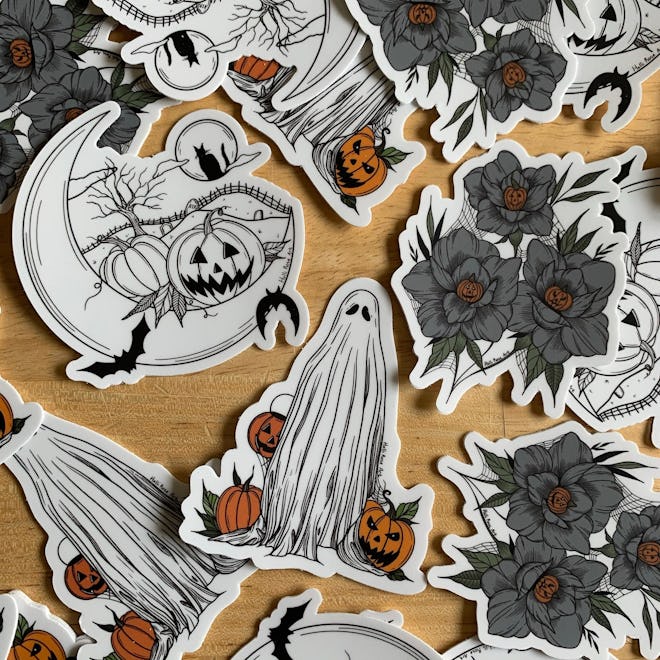 Halloween stickers in a pack of three, one ghost, pumpkin flowers, and moon