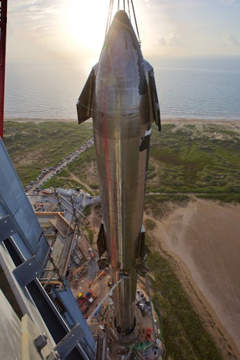 SpaceX Starship stacked with sunlight in the background.