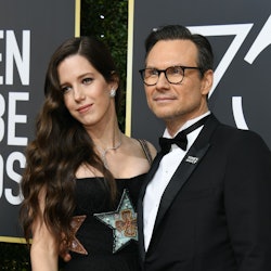 Christian Slater and his wife, Brittany Lopez, posing at the Golden Globe Awards. The couple met whi...