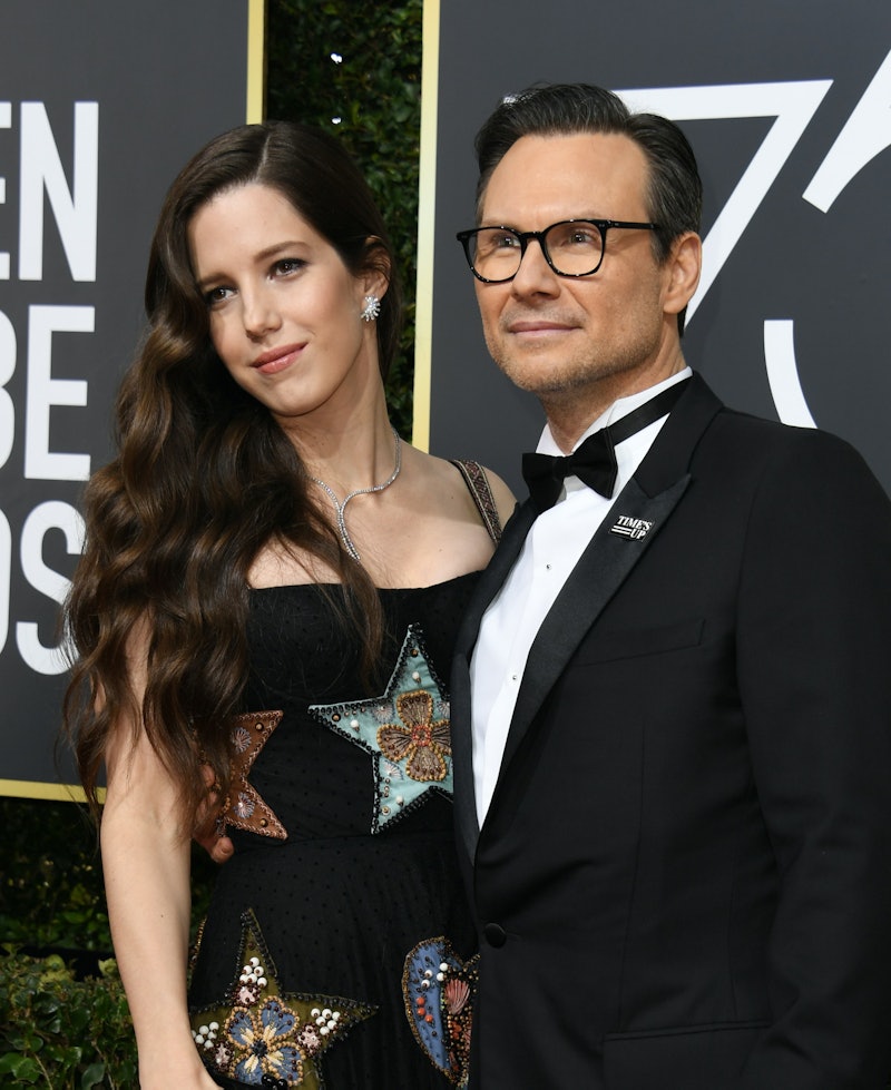 Christian Slater and his wife, Brittany Lopez, posing at the Golden Globe Awards. The couple met whi...