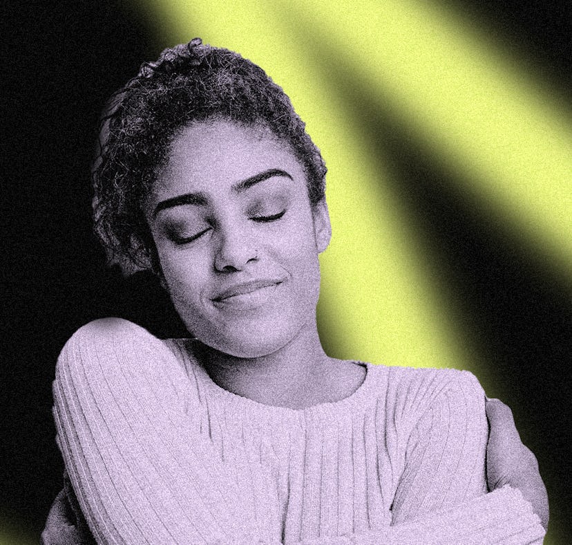 A woman with her eyes closed, embracing herself