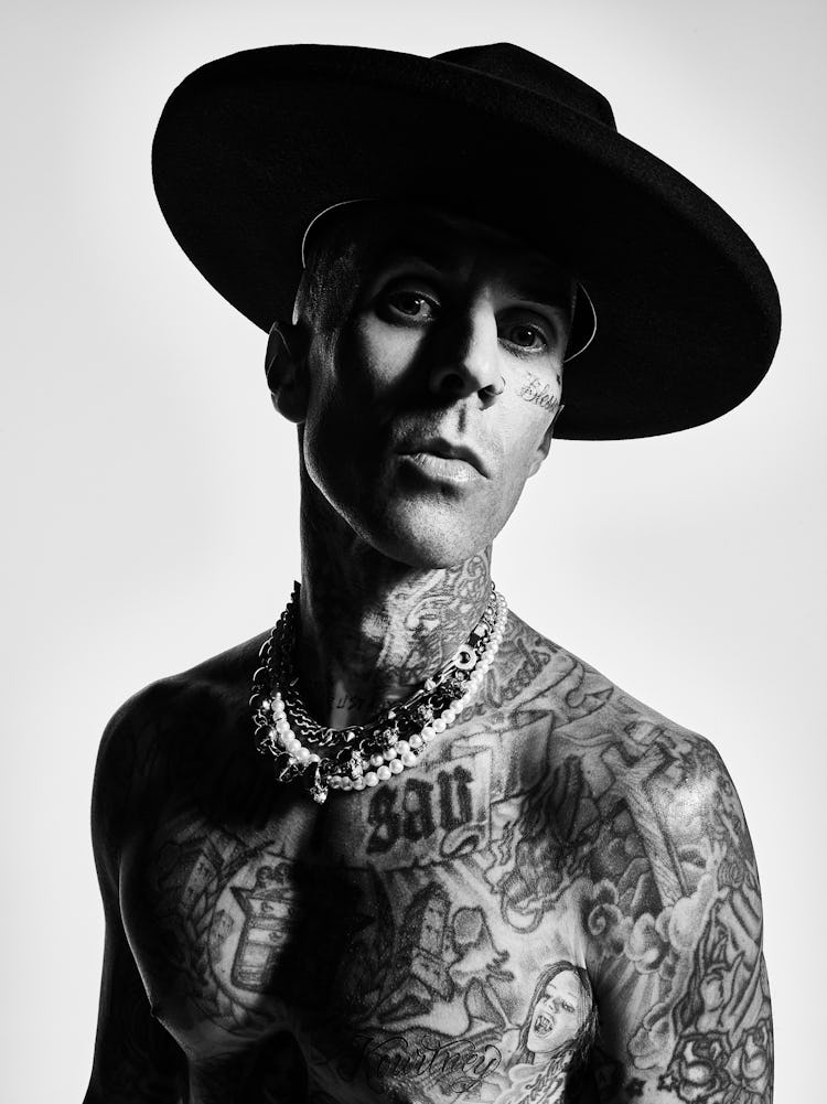A close-up portrait of NYLON cover star Travis Barker in black and white.