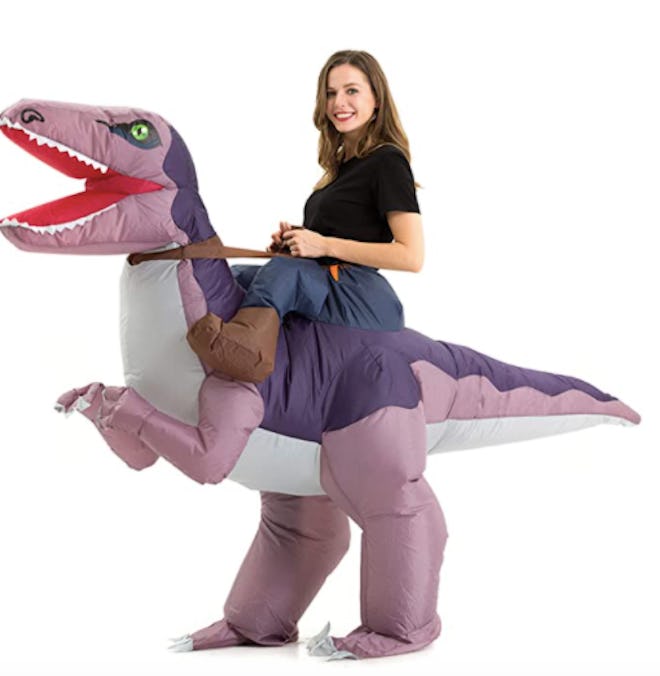 Teen wearing an inflatable dinosaur costume