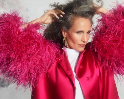 TZR cover star Andie MacDowell poses with her hands in her hair while wearing a pink feathered Gucci...