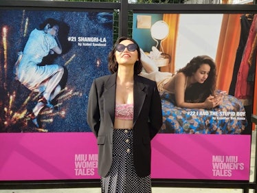 Isabel posing in front of her movie poster