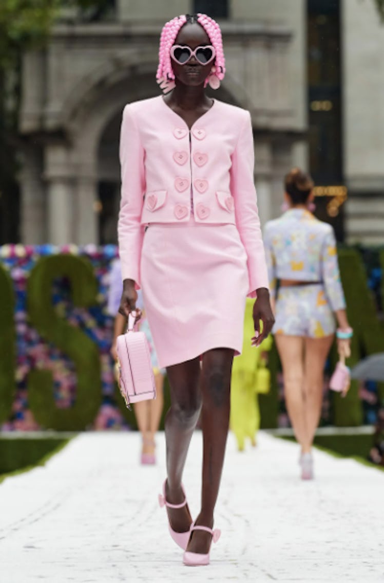 A model wearing a pink Moschino skirt suit during the NYFW Spring 2022