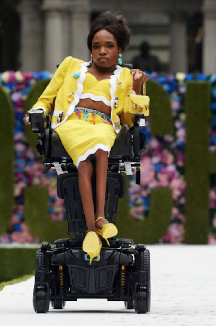 A physically challenged model wearing a yellow Moschino skirt suit during the NYFW Spring 2022