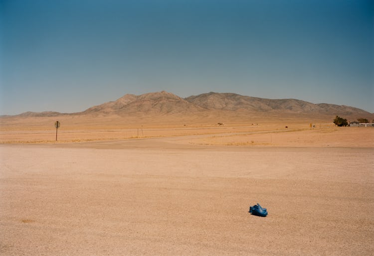 Blue Bottega Veneta shoes in the middle of a desert
