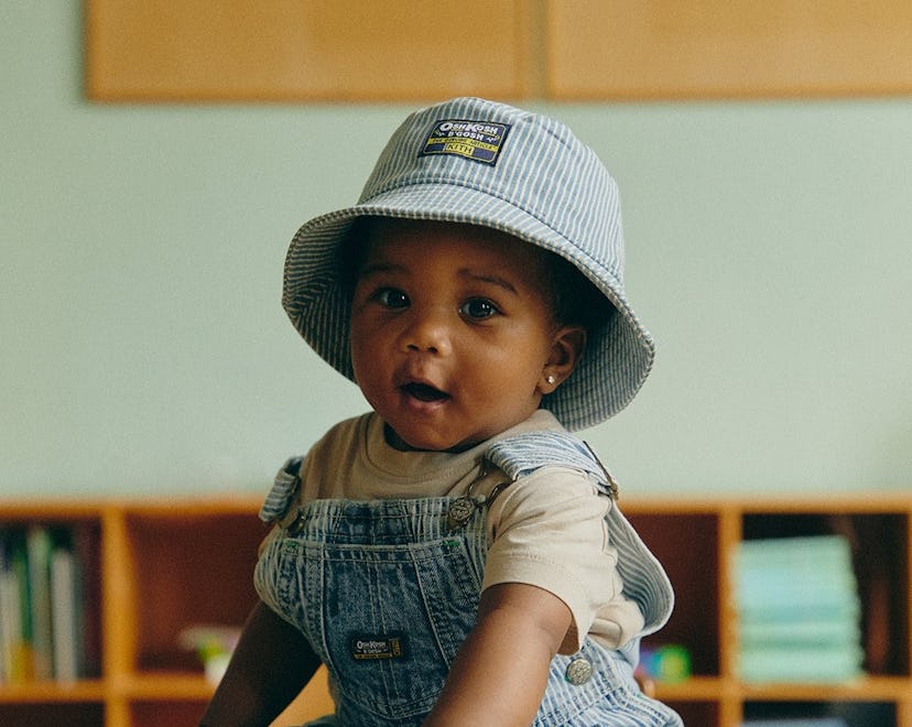 baby wearing osh kosh b'gosh overalls and hat
