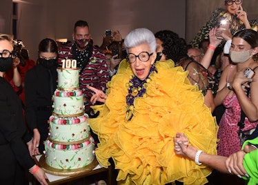 Iris Apfel celebrating her 100th birthday with a fittingly celebratory cake
