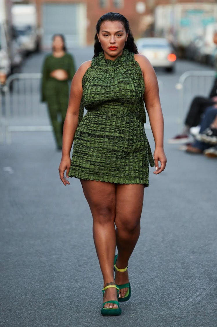 A model wearing a short green dress by Eckhaus Latta during New York Fashion Week Spring 2022