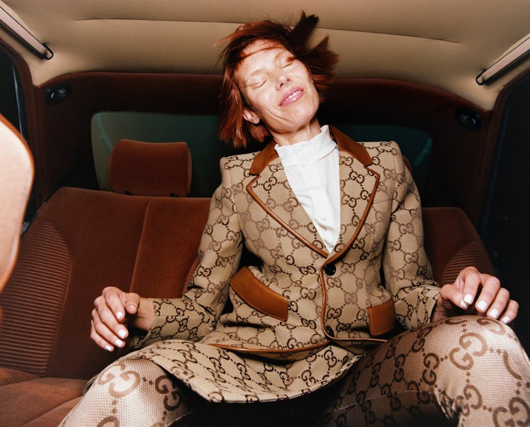 Hella Lund posing in a Gucci jacked, skirt and tights while sporting a subtly glowing skin look