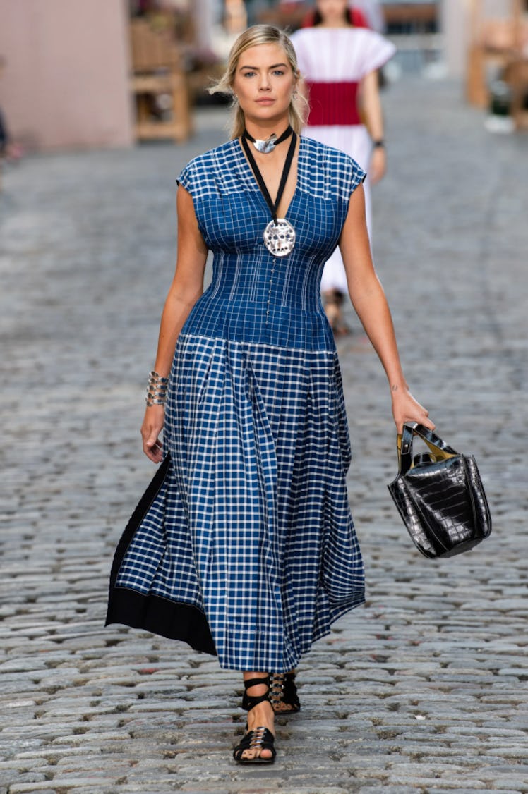 A model wearing a blue checked dress by Tory Burch during New York Fashion Week Spring 2022