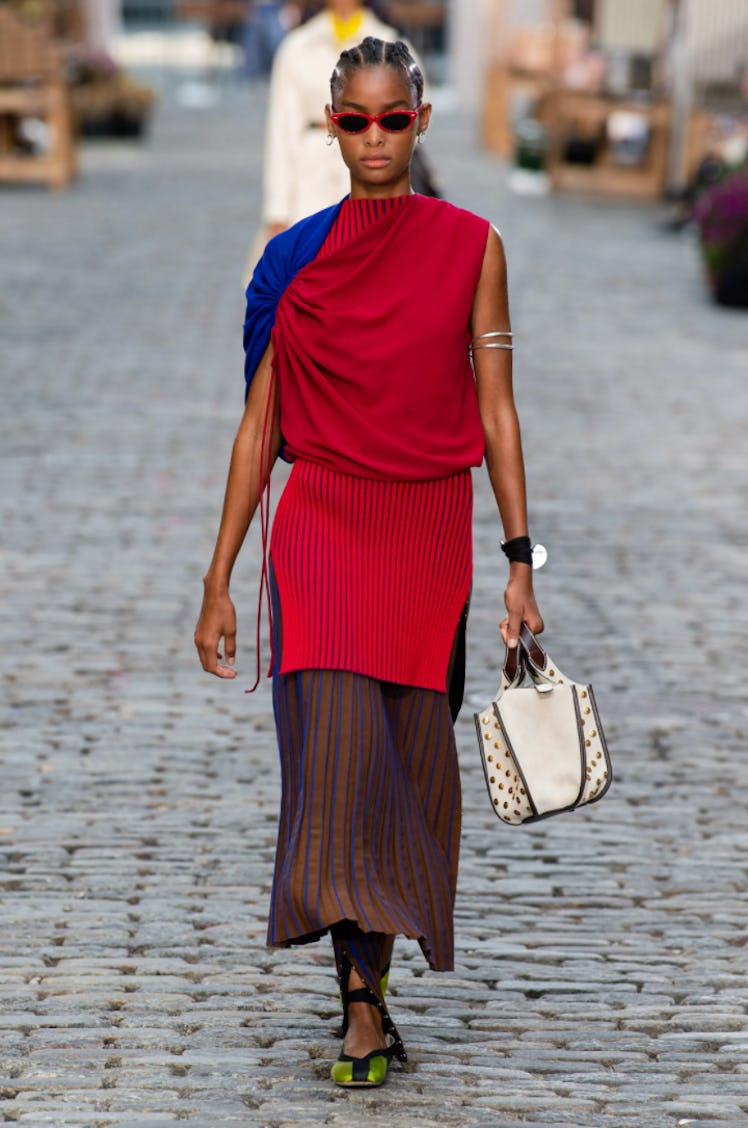 A model wearing a pleated dress by Tory Burch during New York Fashion Week Spring 2022