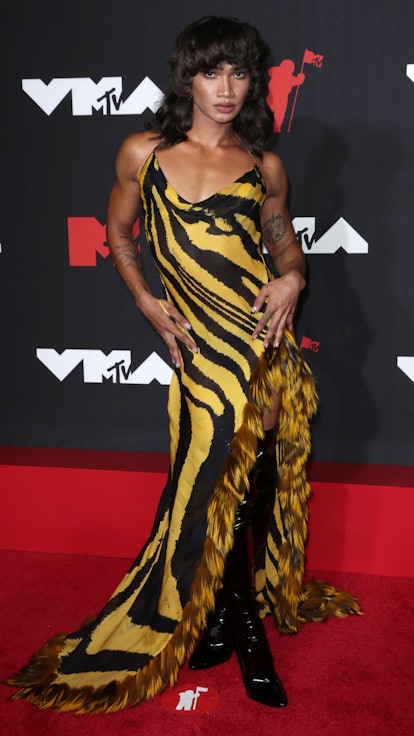 Bretman Rock at the 2021 VMAs in a yellow-and-black striped gown formerly worn by Aaliyah in 2001.