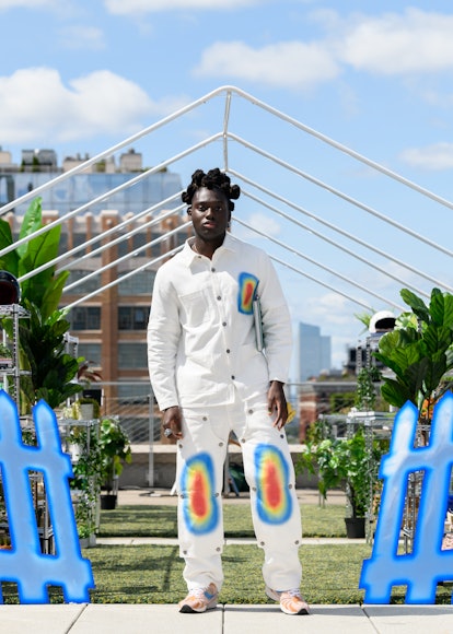 A model in an all-white set from Tombogo's "Nature Is Healing" with heat map patterns on the jeans &...