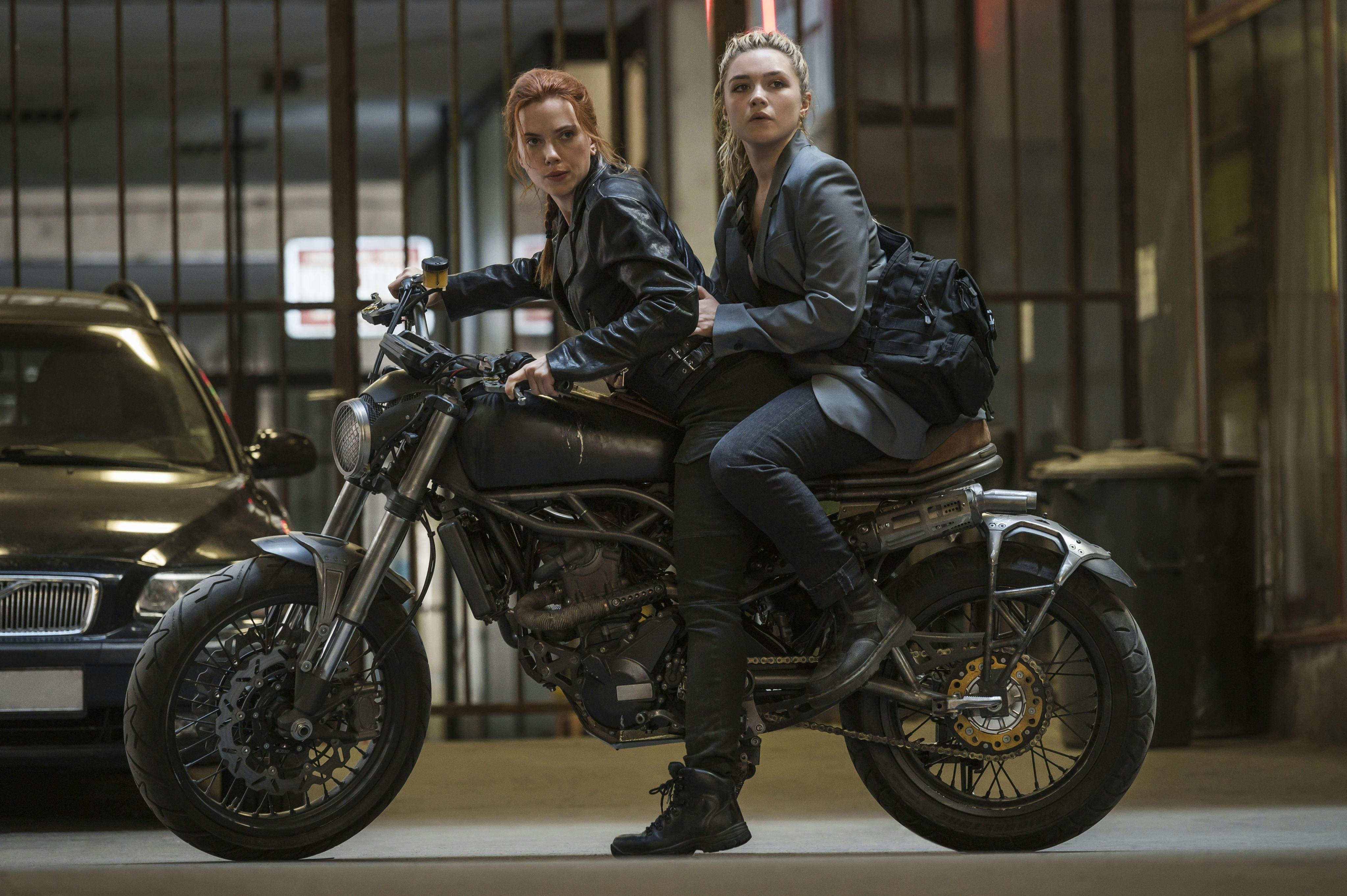 A still from &lsquo;Black Widow,&rsquo; with Scarlett Johansson and Florence Pugh on top of a motorcycle.