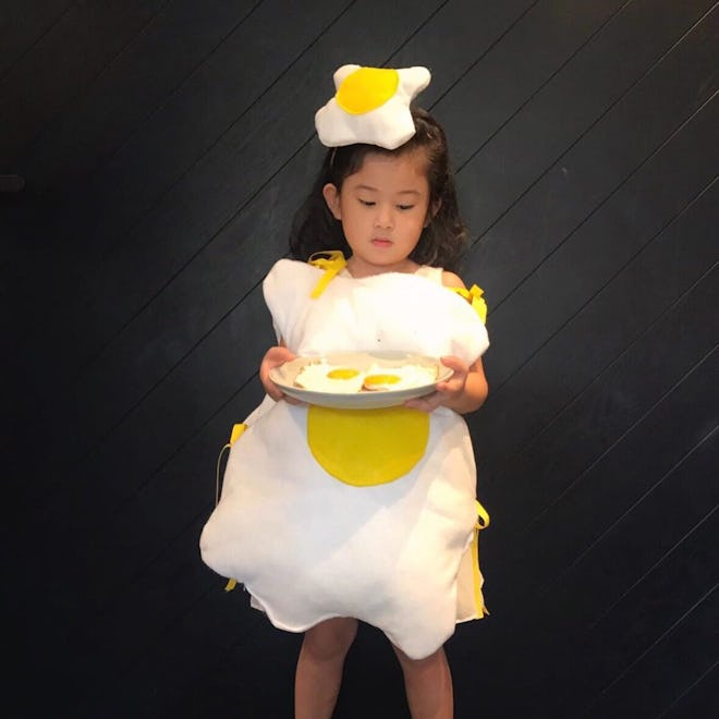 Little girl dressed up as fried egg