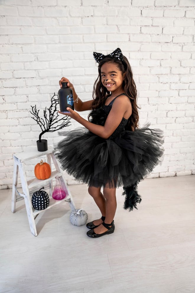 Little girl dressed up in black cat tutu costume