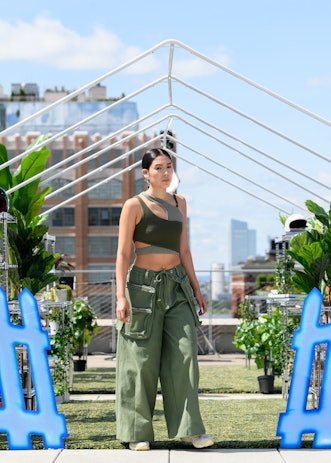 A model in a piece from Tombogo's "Nature Is Healing": a green and grey layered crop top and green l...