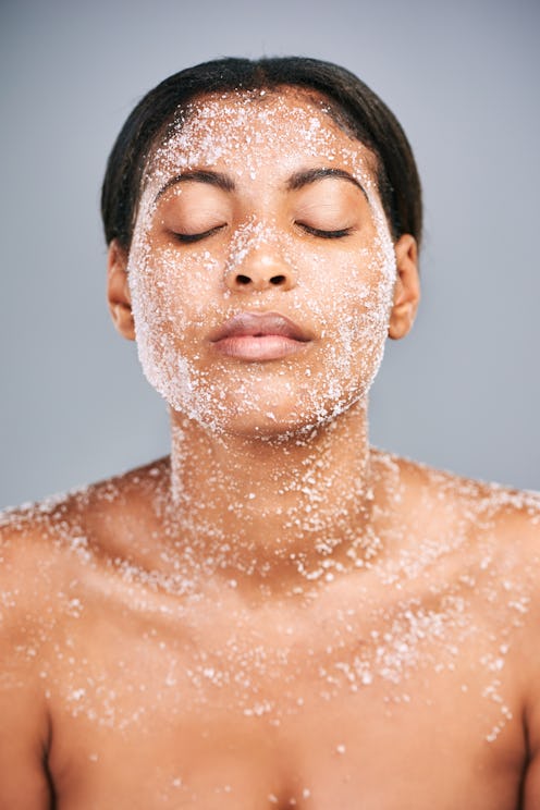 Woman using face scrub