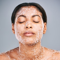 Woman using face scrub