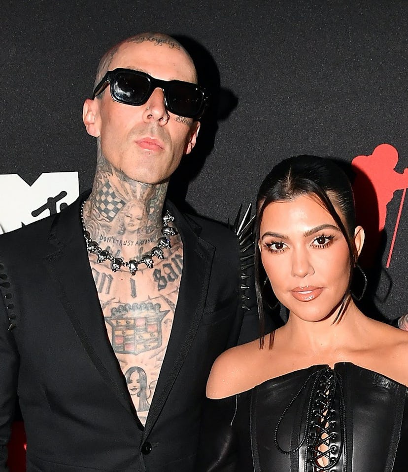 Travis Barker and Kourtney Kardashian kissing on the red carpet at the 2021 VMAs.