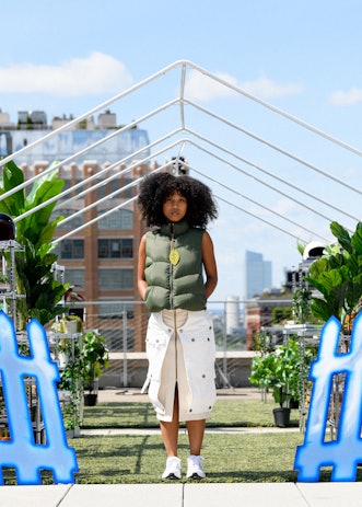 A model in a piece from Tombogo's "Nature Is Healing": green puffer vest with a leaf-shaped zipper a...