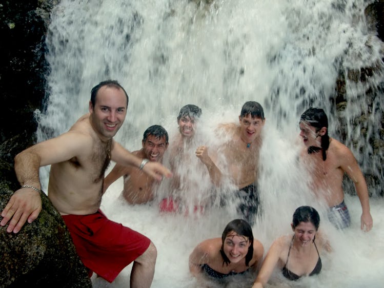Couchsurfing team under a waterfall in Mexico in 2010