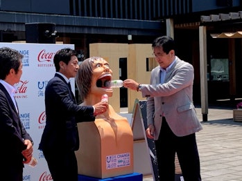 Officials unveiling Attack on Titan reclycing bins in Oita 