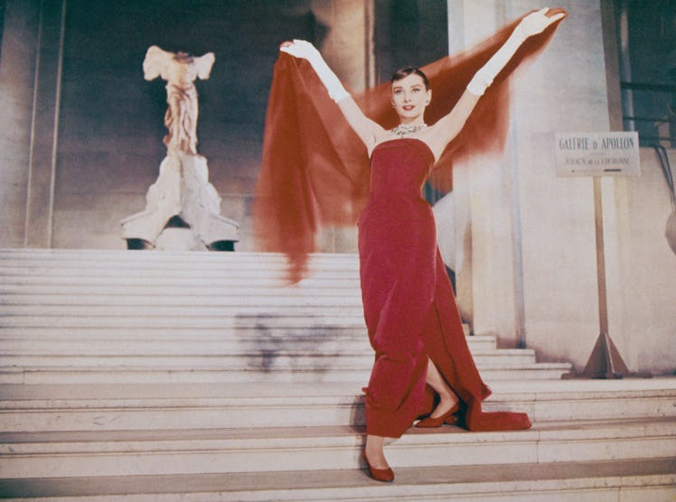 Actress Audrey Hepburn (1929 - 1993) descends the Daru Staircase at the Louvre in Paris, in a scene ...