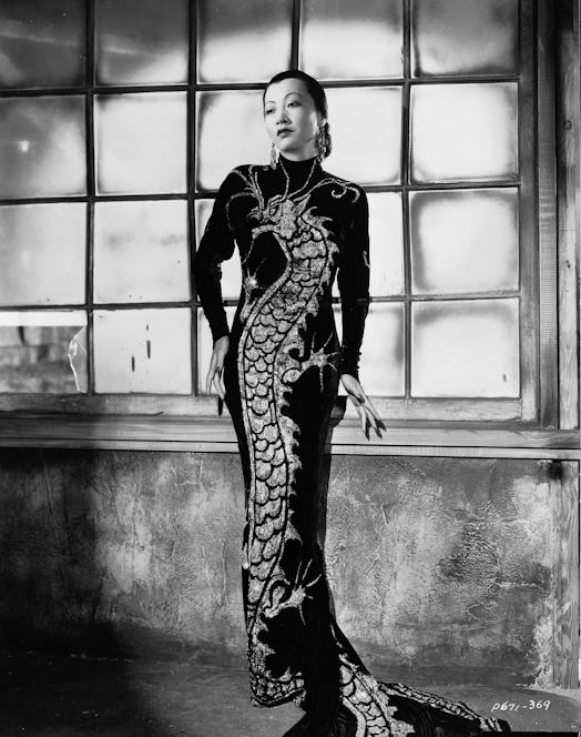 Chinese-American film star, Anna May Wong (1905 - 1961) wearing a dress with dragon motif in a publi...