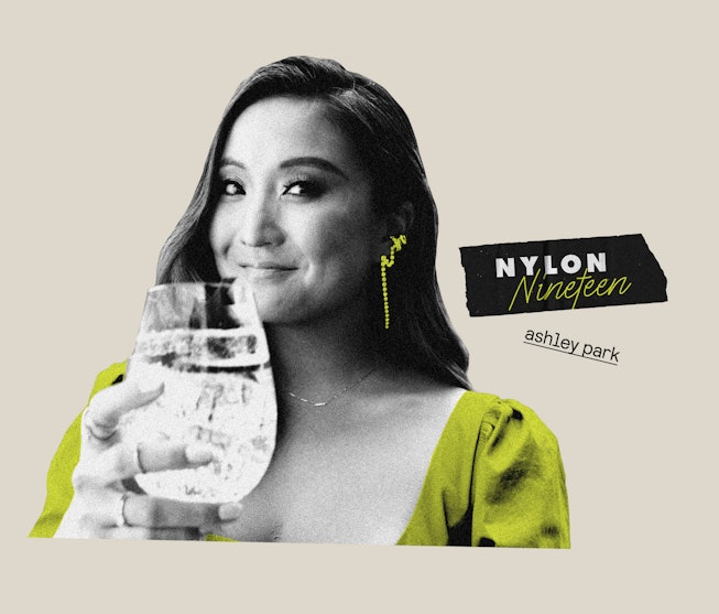 Ashley Park holds a drink as she answers the questions for "Nylon Nineteen"