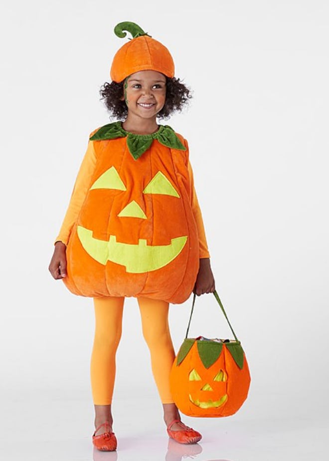 Little girl posing in Jack-o-lantern costume