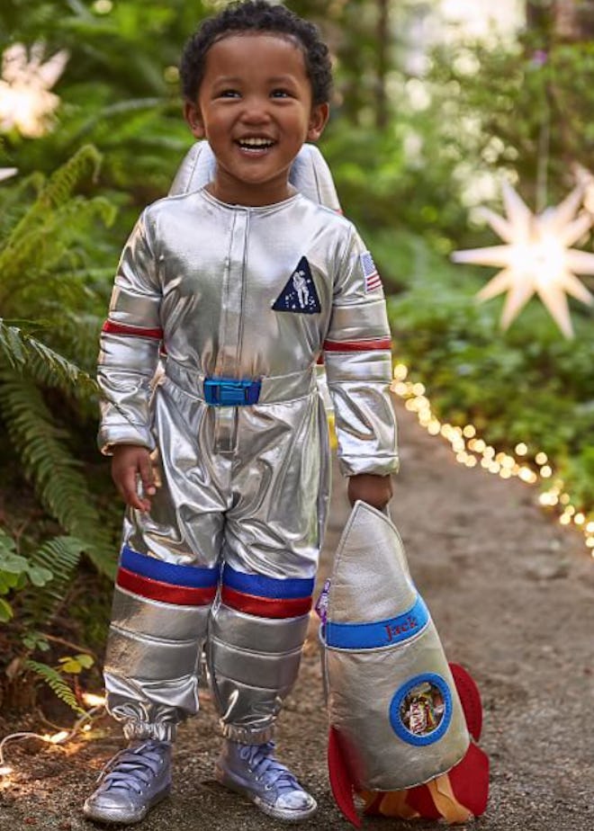 Little boy posing in astronaut costume