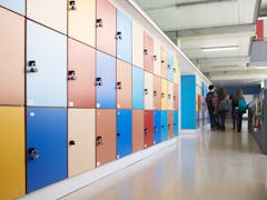 Students seen at the end of a long hallway lined with lockers