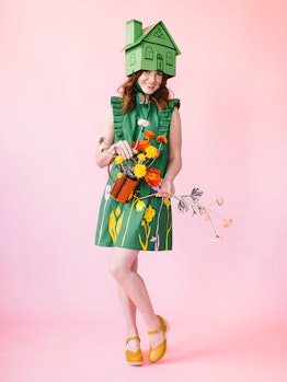 "Greenhouse" Halloween costume featuring a woman in a green dress with flowers and a cardboard house...