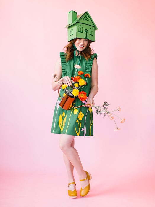"Greenhouse" Halloween costume featuring a woman in a green dress with flowers and a cardboard house...