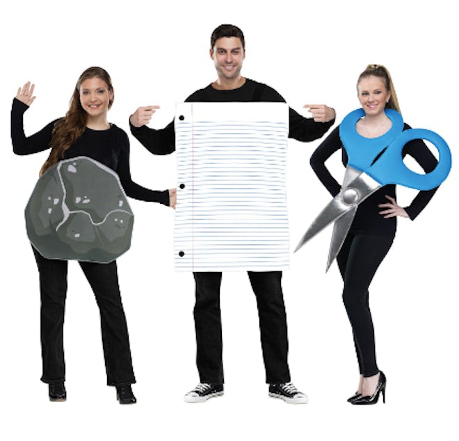 Three adults dressed as rock, paper, and scissors