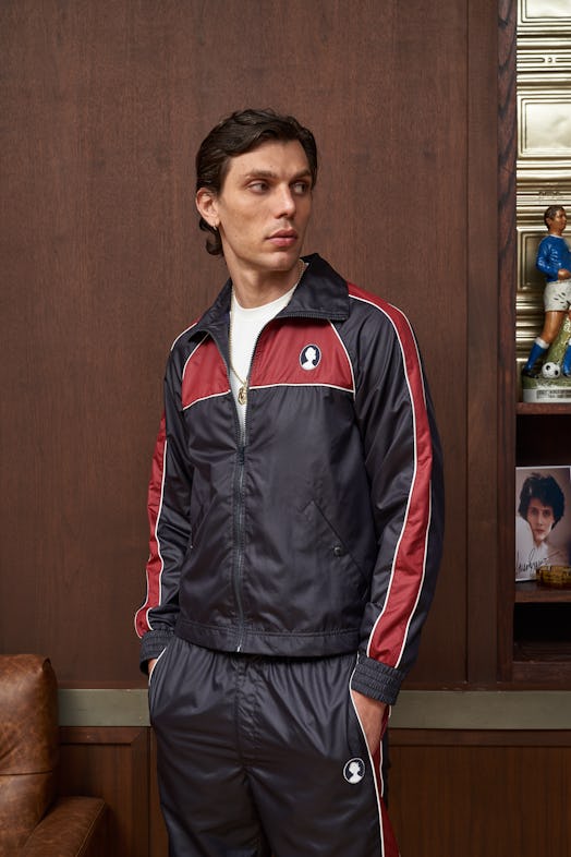 model wearing navy blue and maroon tracksuit