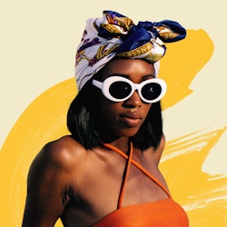A woman with self-tanner applied on her skin wearing an orange bikini, sunglasses and a scarf wrappe...